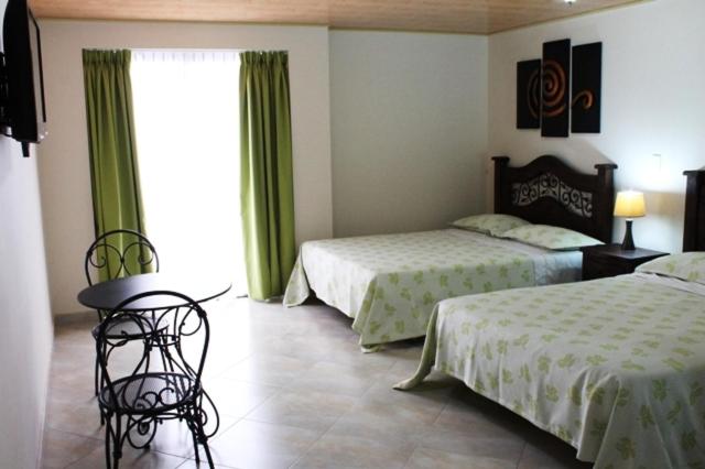 Postel nebo postele na pokoji v ubytování Hoteles Bogotá Inn Park Way