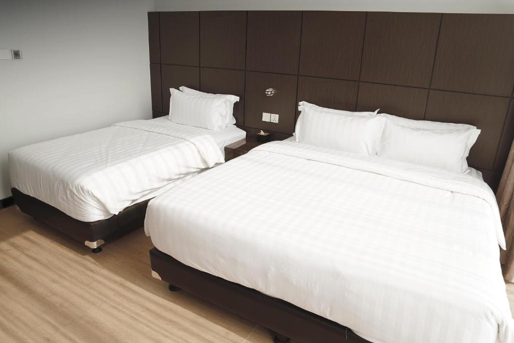 Postel nebo postele na pokoji v ubytování Dreamtel Jakarta