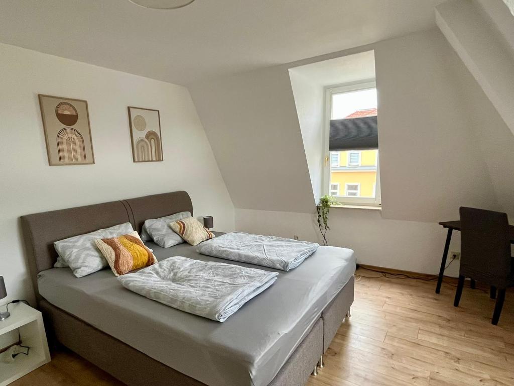 a room with a bed with two pillows on it at Ferienwohnung für 5 Personen in Dresden