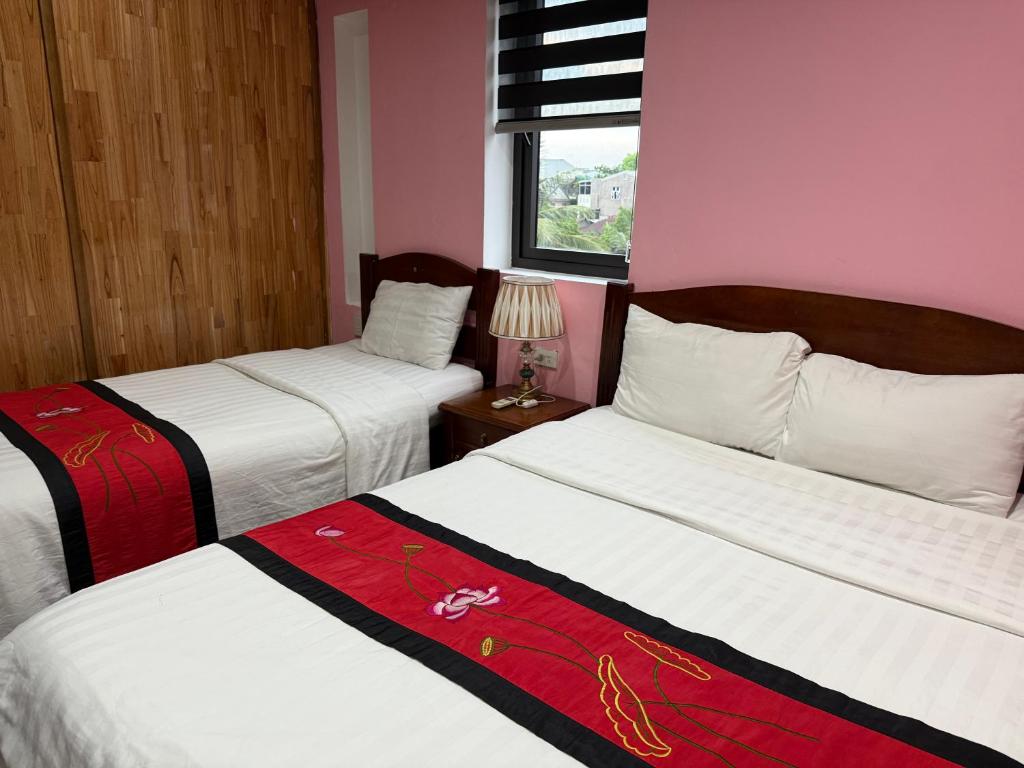 Giường trong phòng chung tại Maison Vu Tri Vien
