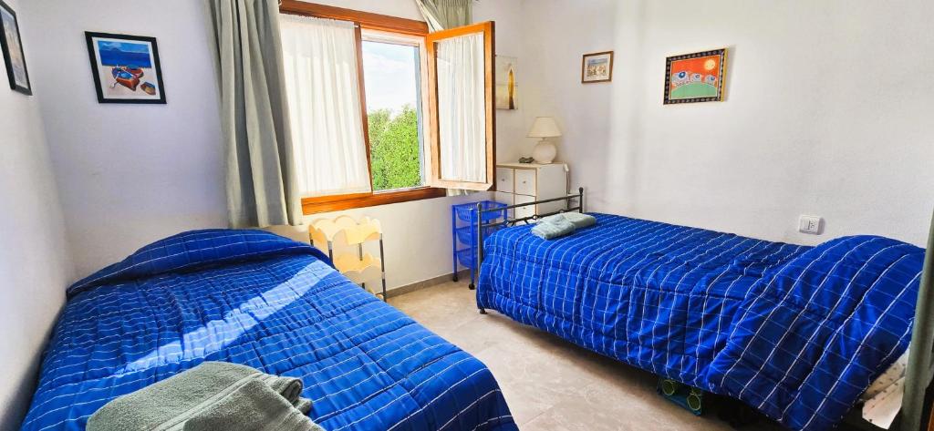 Postel nebo postele na pokoji v ubytování VILLA HELIOS Villa en Cala Pi con vistas despejadas