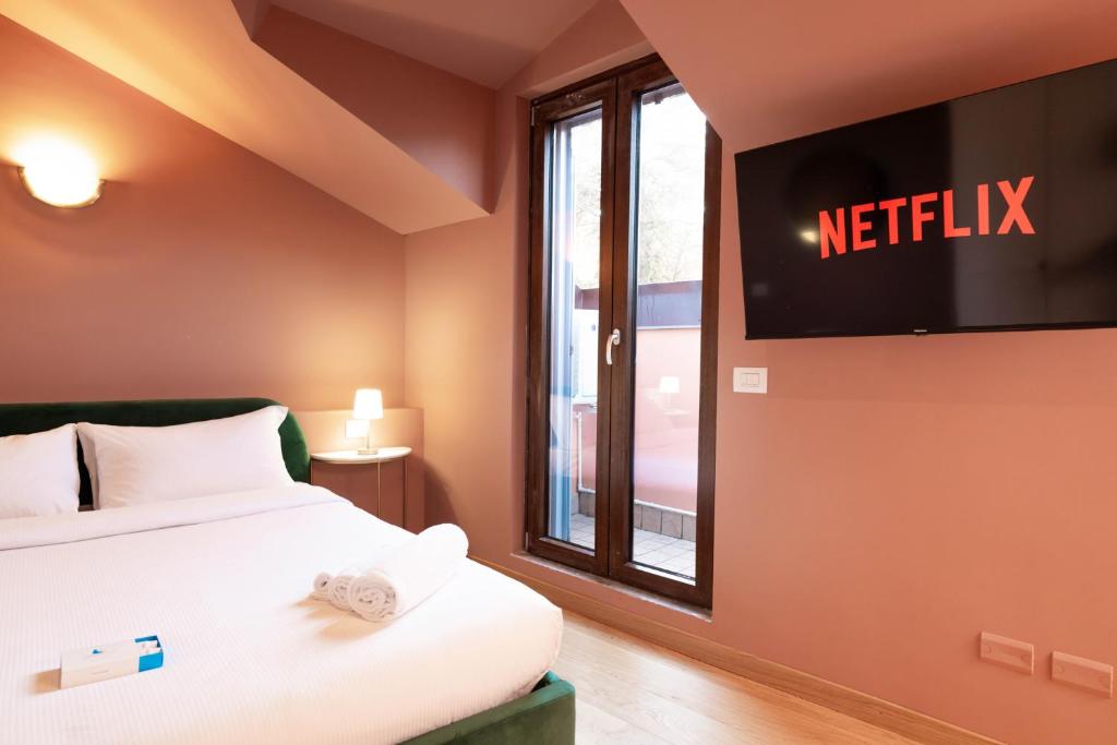 Postel nebo postele na pokoji v ubytování San Giuseppe Suite Lake Como