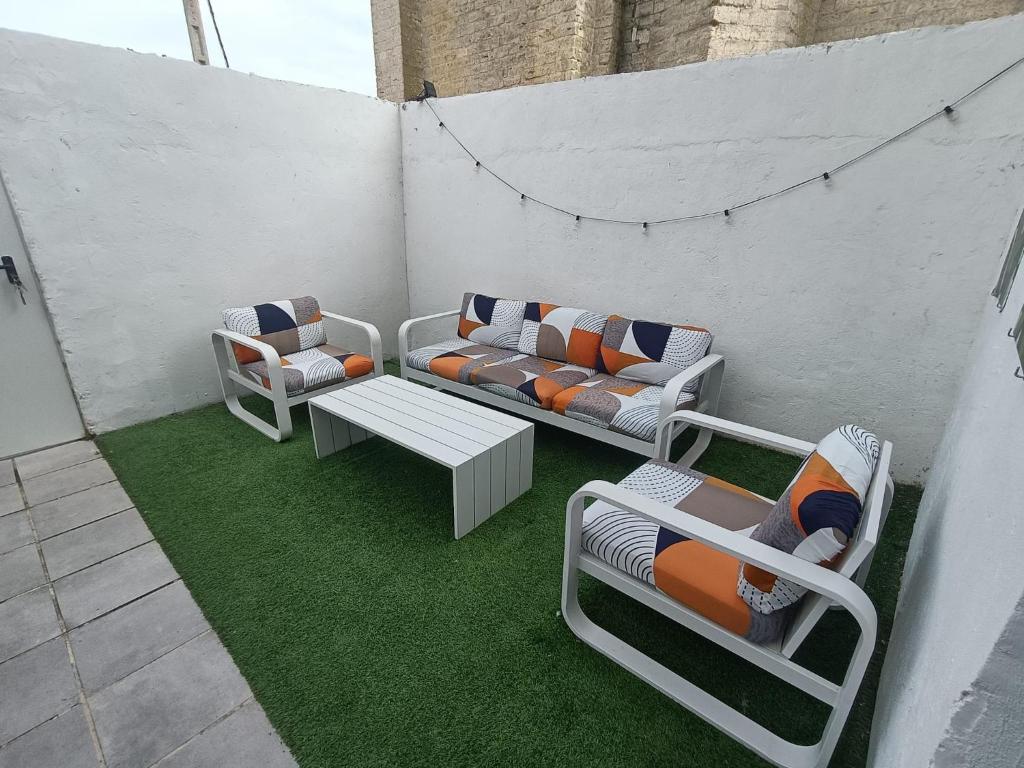 a patio with couches and a table and chairs at Casa Nentis in Mucientes
