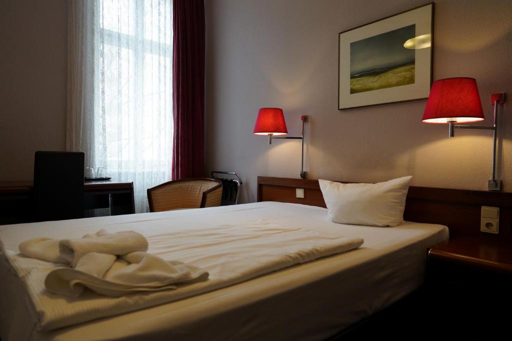 Postel nebo postele na pokoji v ubytování Hotel Xantener Eck