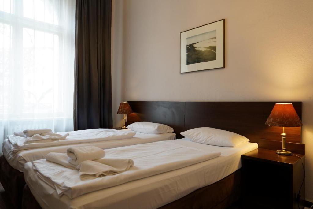 Postel nebo postele na pokoji v ubytování Hotel Xantener Eck
