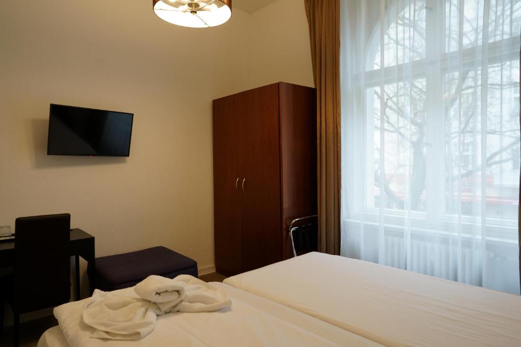Postel nebo postele na pokoji v ubytování Hotel Xantener Eck