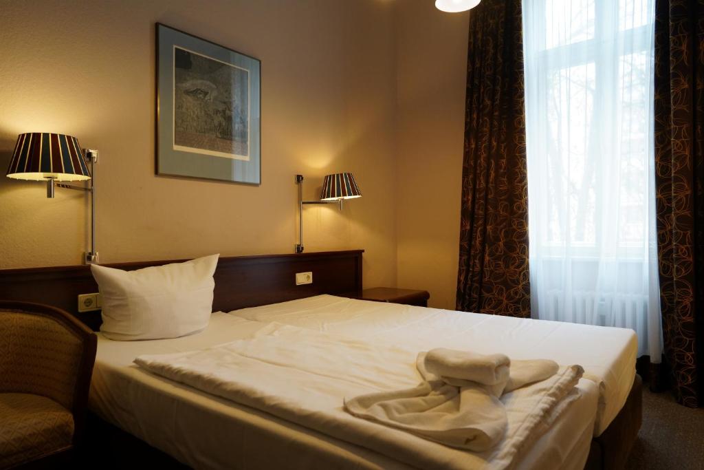 Postel nebo postele na pokoji v ubytování Hotel Xantener Eck