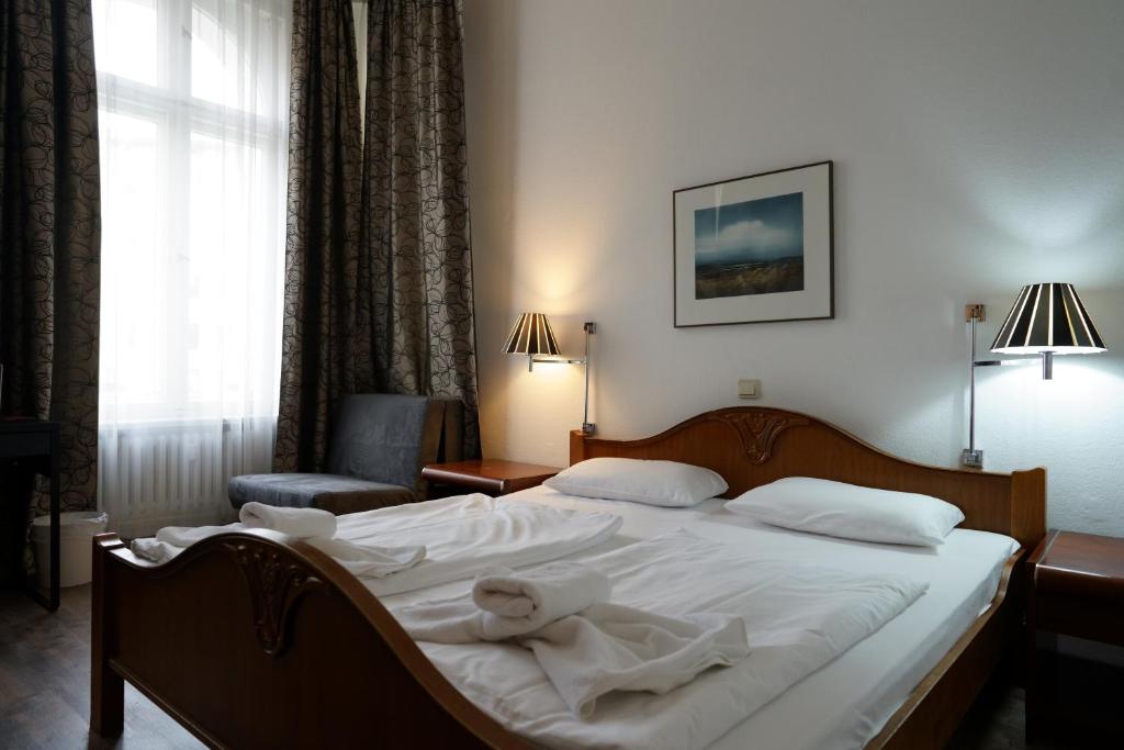 Postel nebo postele na pokoji v ubytování Hotel Xantener Eck