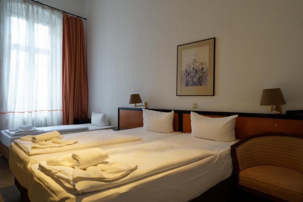 Postel nebo postele na pokoji v ubytování Hotel Xantener Eck