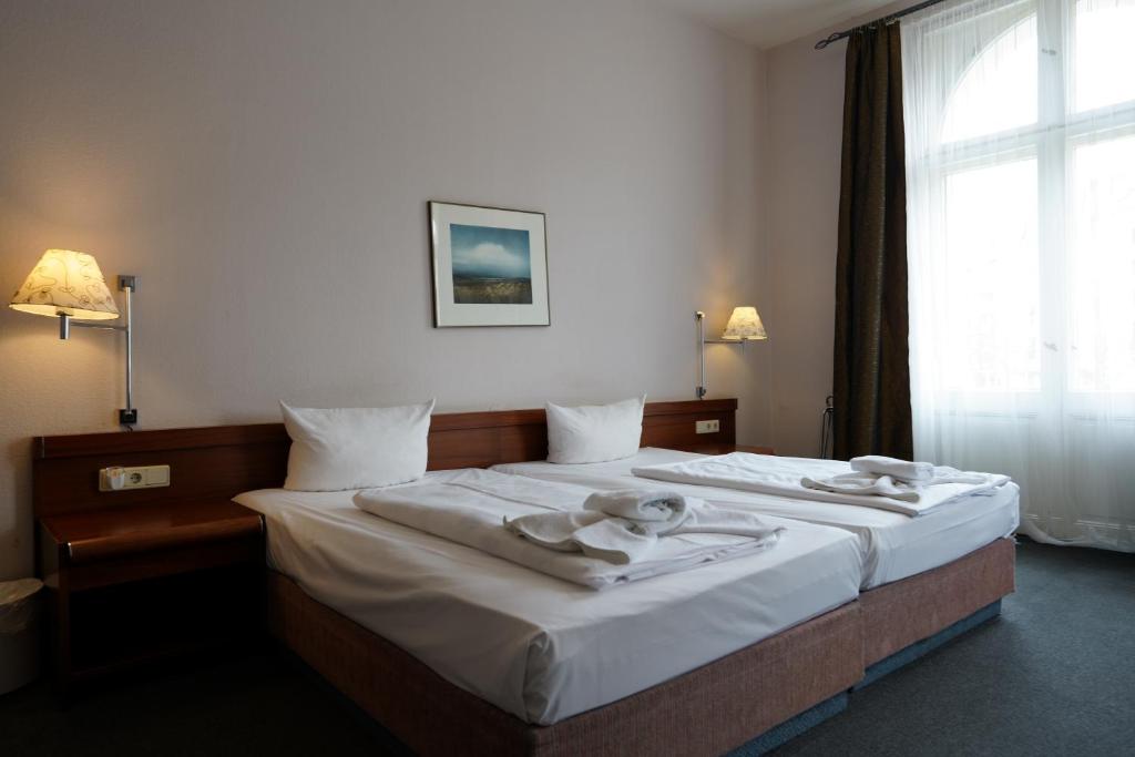 Postel nebo postele na pokoji v ubytování Hotel Xantener Eck