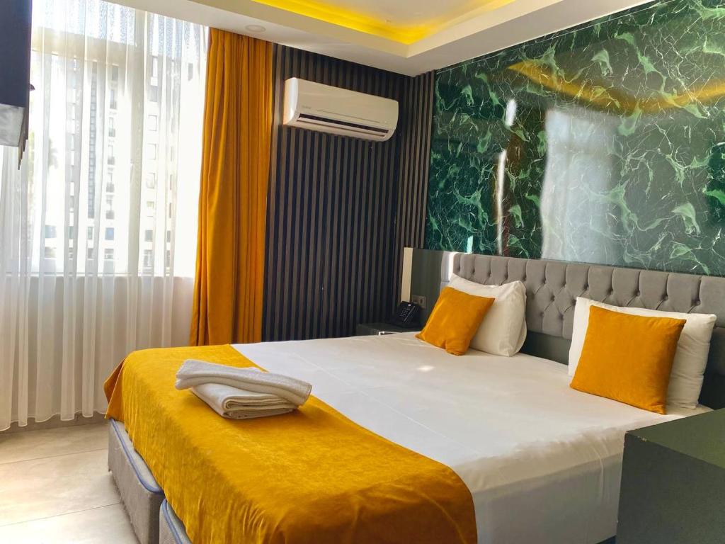 A bed or beds in a room at ERDEM HOTEL