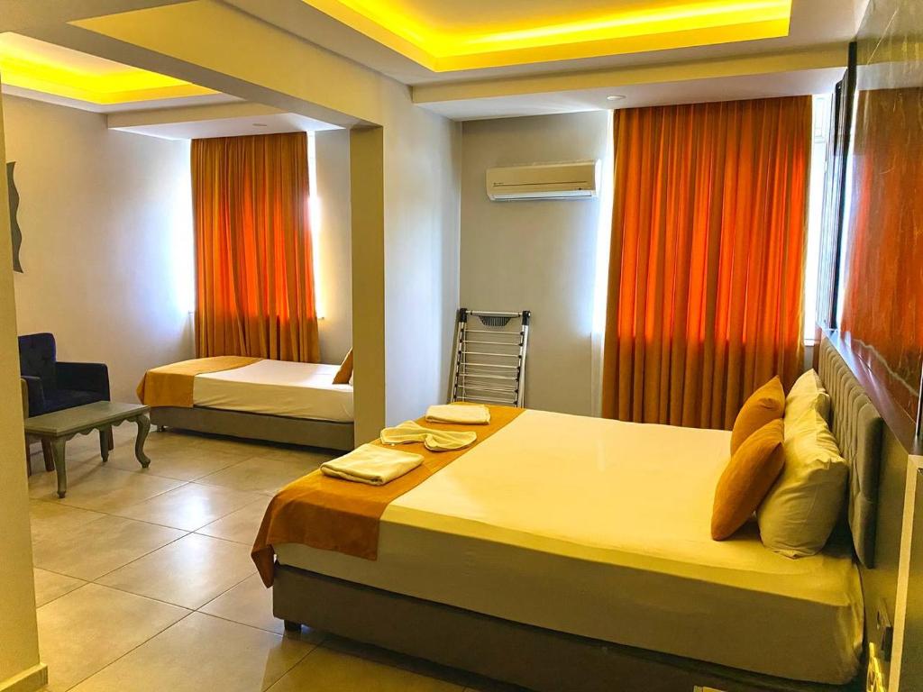 A bed or beds in a room at ERDEM HOTEL
