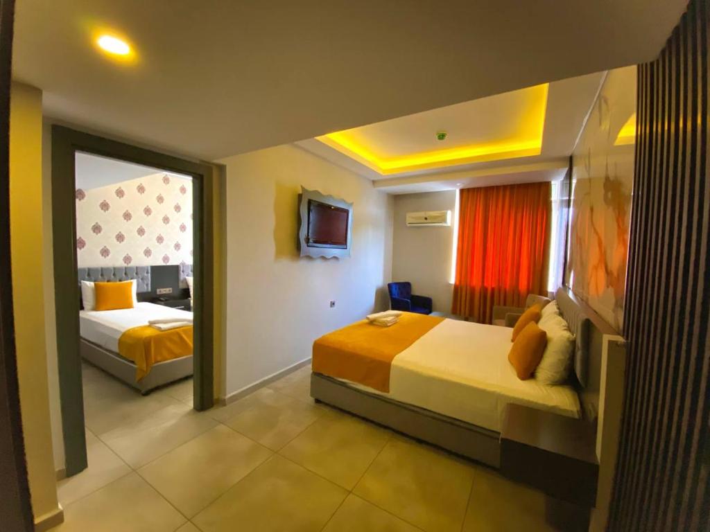 A bed or beds in a room at ERDEM HOTEL