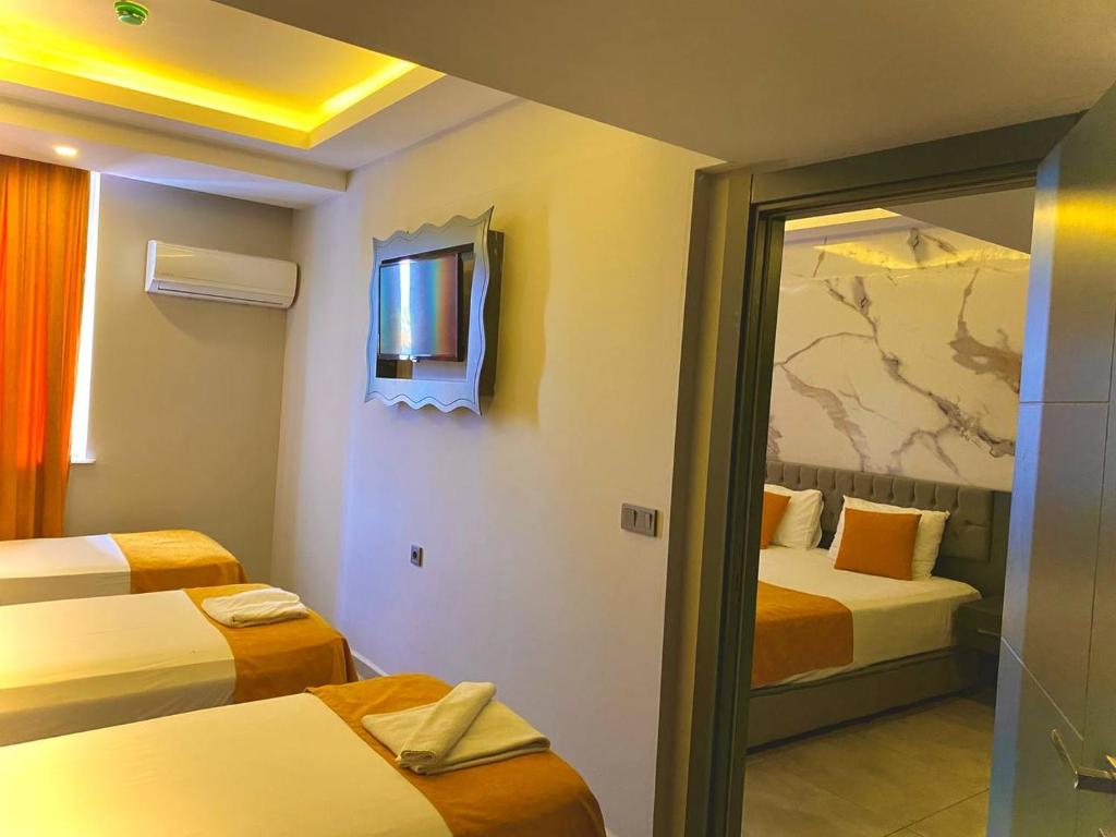 A bed or beds in a room at ERDEM HOTEL