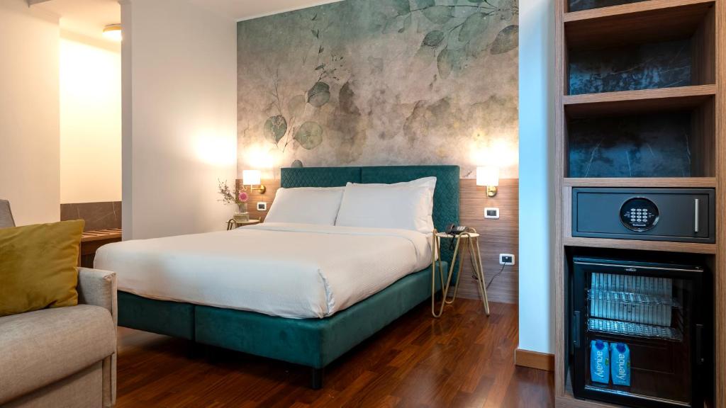 Postel nebo postele na pokoji v ubytování Gardone Palace Hotel