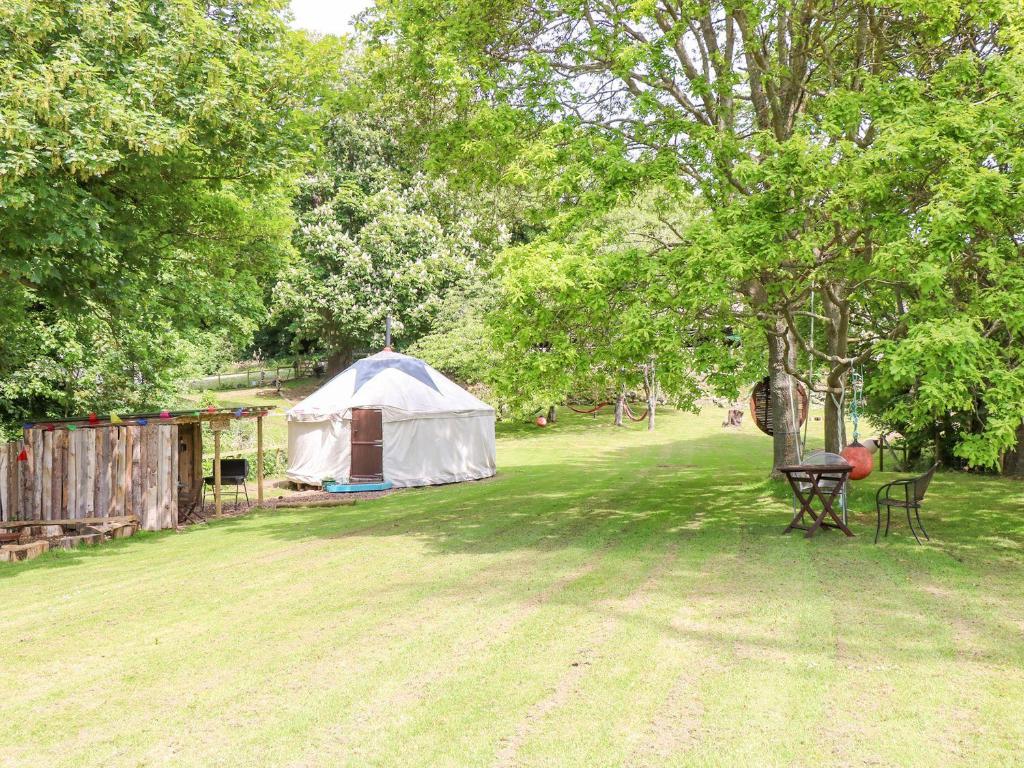 a yurt with a table and chairs in a yard at Stardust in Ventnor