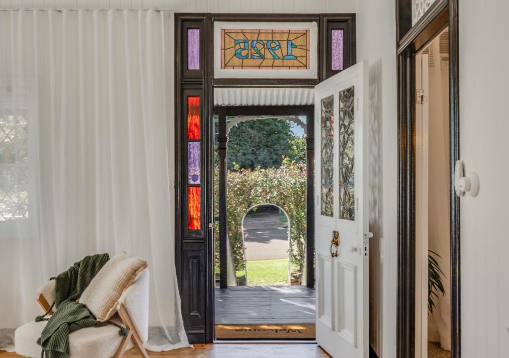 an open door with a view of a yard at Character CBD Cottage in Toowoomba
