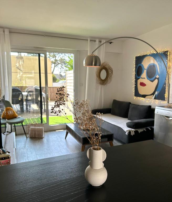 un salon avec un canapé et une table dans l'établissement Ile tudy Bord de plage et farniente en terrasse Appt classé 3 étoiles, à l'Île-Tudy