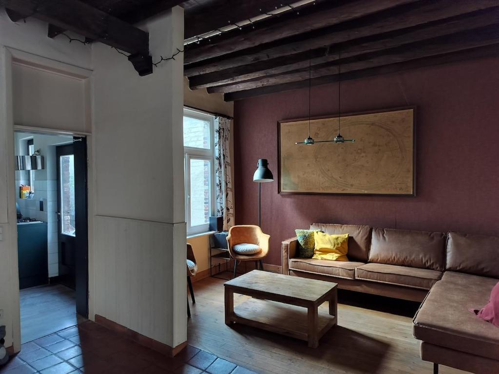 a living room with a couch and a table at Holidayhouse Balie in Bruges