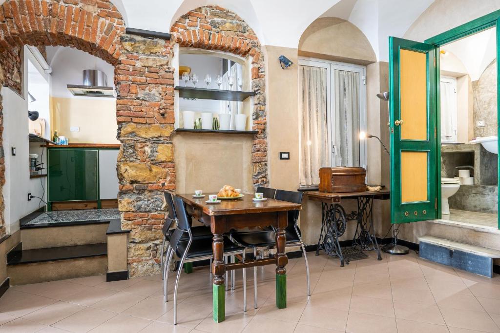 a kitchen with a table and a brick wall at lovingenoa Natural - Light in Genoa