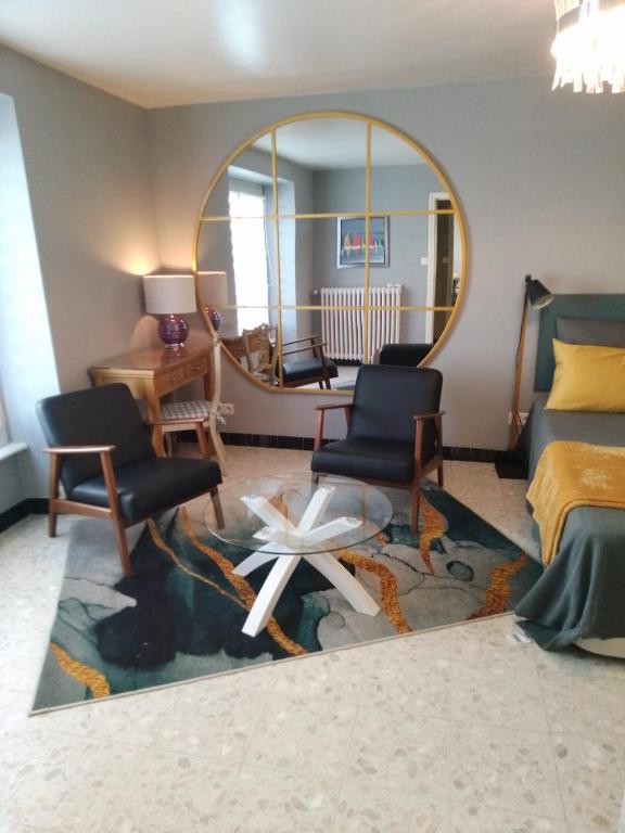 une chambre avec un miroir, deux chaises et un lit dans l'établissement T1bis, 100m de la belle plage de Morgat, à Crozon