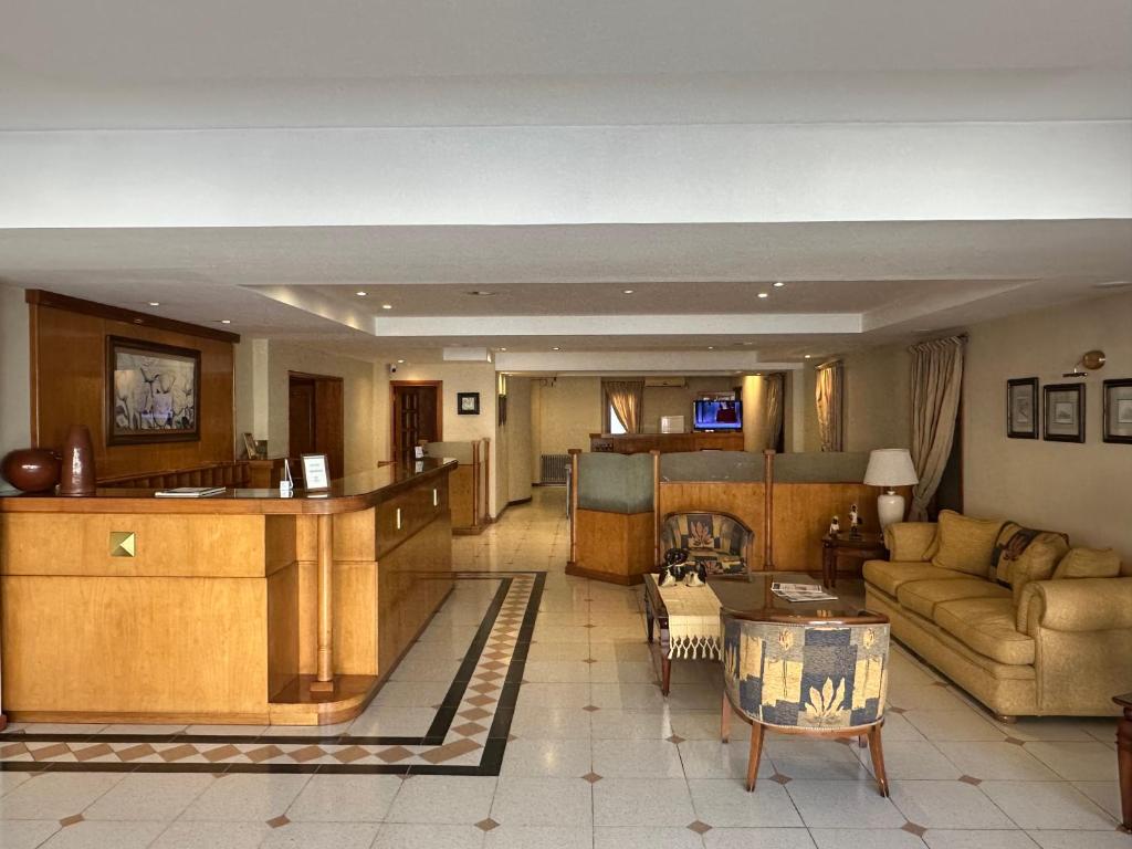 a living room with a couch and a table at Hotel Piero in Villa Mercedes
