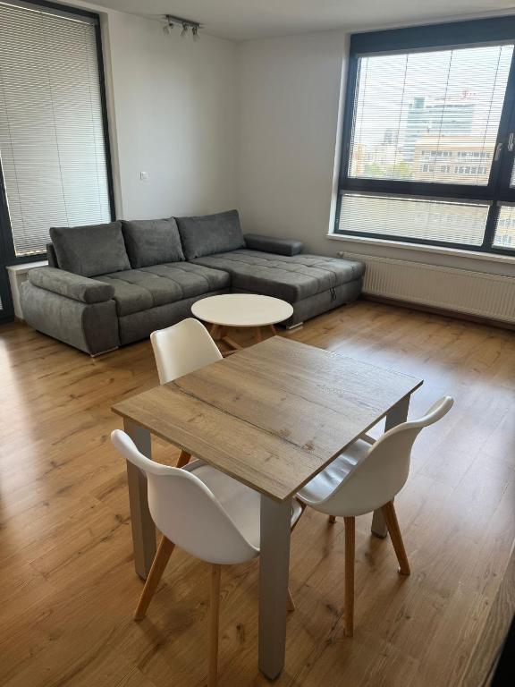 a living room with a table and chairs and a couch at CityPark Apartment, free parking & AC in Bratislava