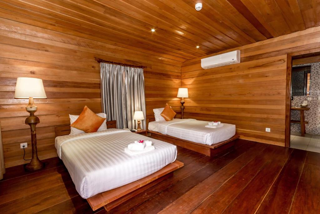 Een bed of bedden in een kamer bij Angkor Heart Bungalow