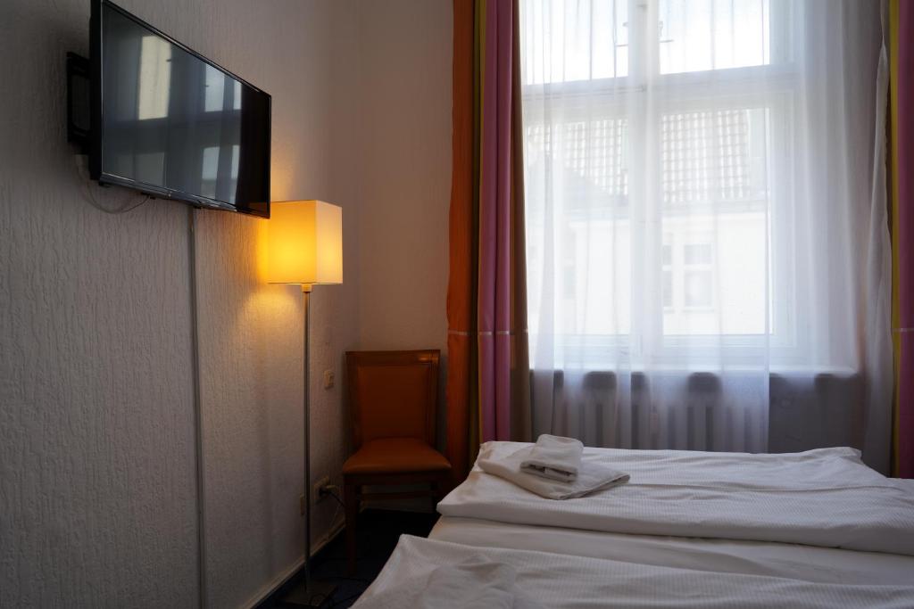 Postel nebo postele na pokoji v ubytování Hotel Ambert