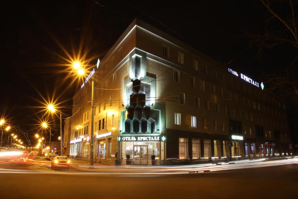 a building on a street at night with lights at Crystal Hotel in Kazan