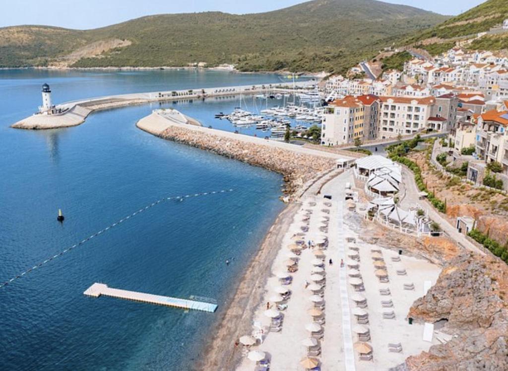 an aerial view of a marina with boats in the water at Lustica Bay Piazza Apartment in Radovići