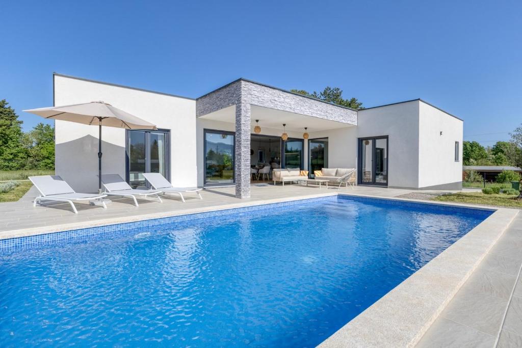 a villa with a swimming pool and a house at Villa Marina in Kršan