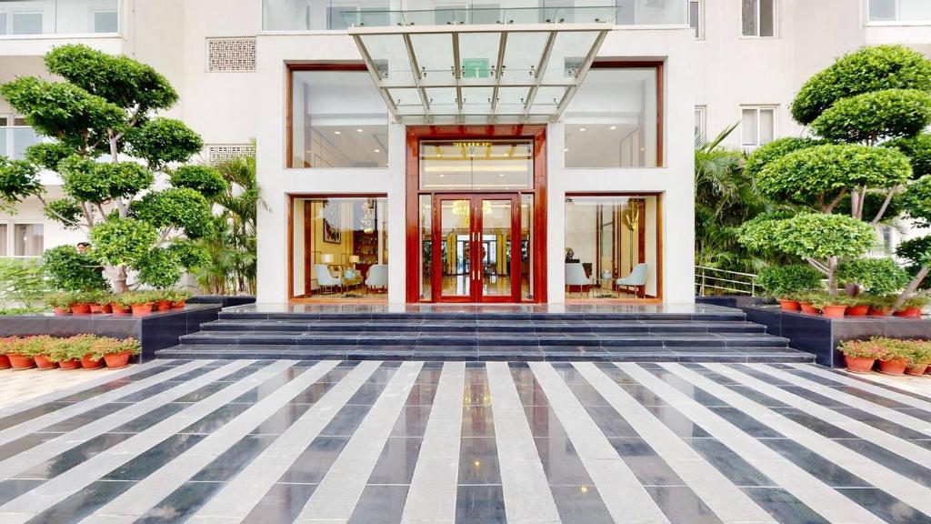 a facade of a building with a red door at Relaxing 1BHK Retreat with Pool View in Gurgaon