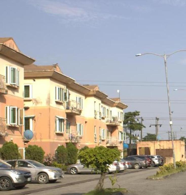 a parking lot with cars parked in front of buildings at The Vistana 4Bedroom Pearly Gate Estate Ikota VGC Lekki in Igboshere