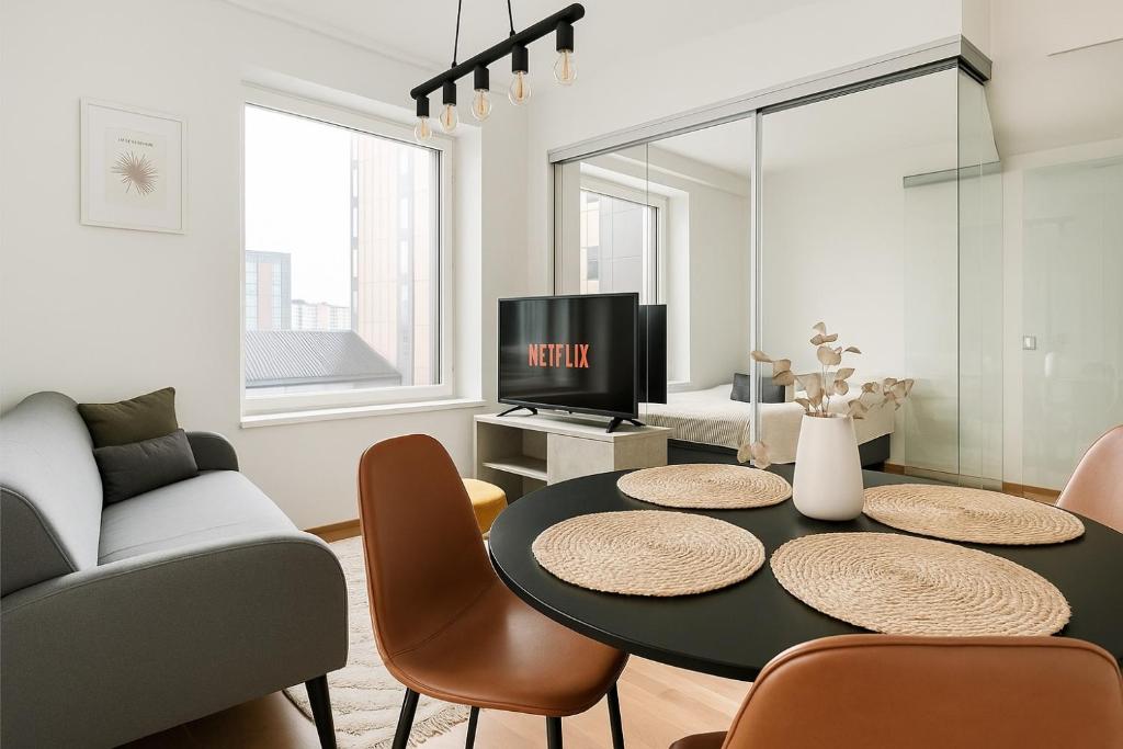 a living room with a table and a couch at Tammer Huoneistot - City Suite 6 - Best Location & Great Amenities in Tampere