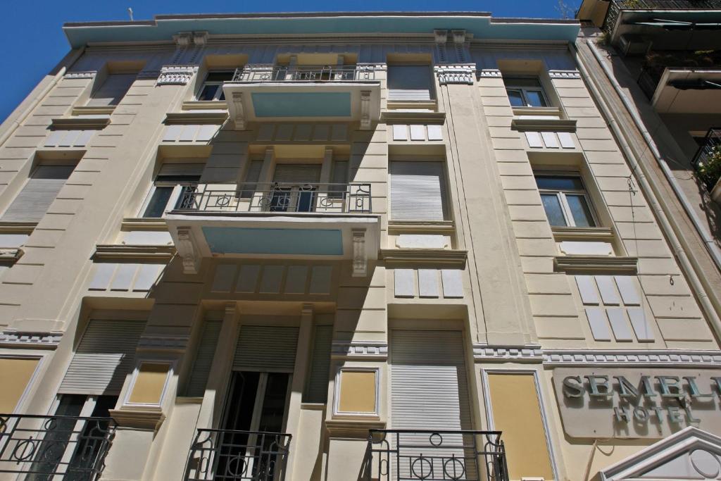 a tall building with balconies on the side of it at Semeli Hotel in Athens