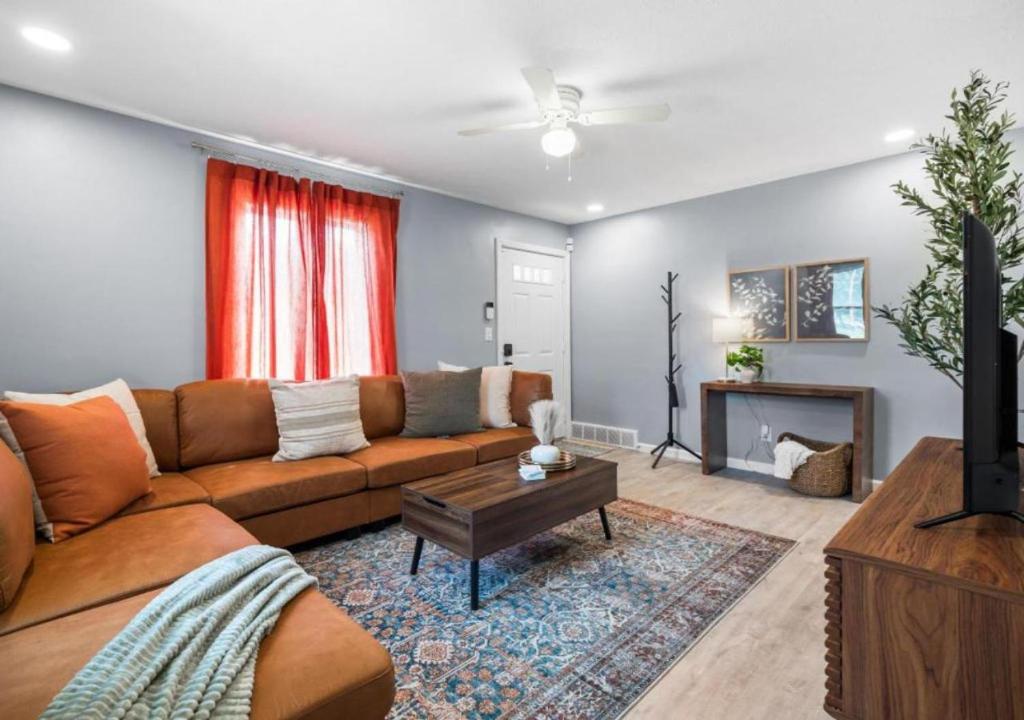 a living room with a couch and a table at Expertly Designed Lake Erie Escape with Hot Tub in Lorain