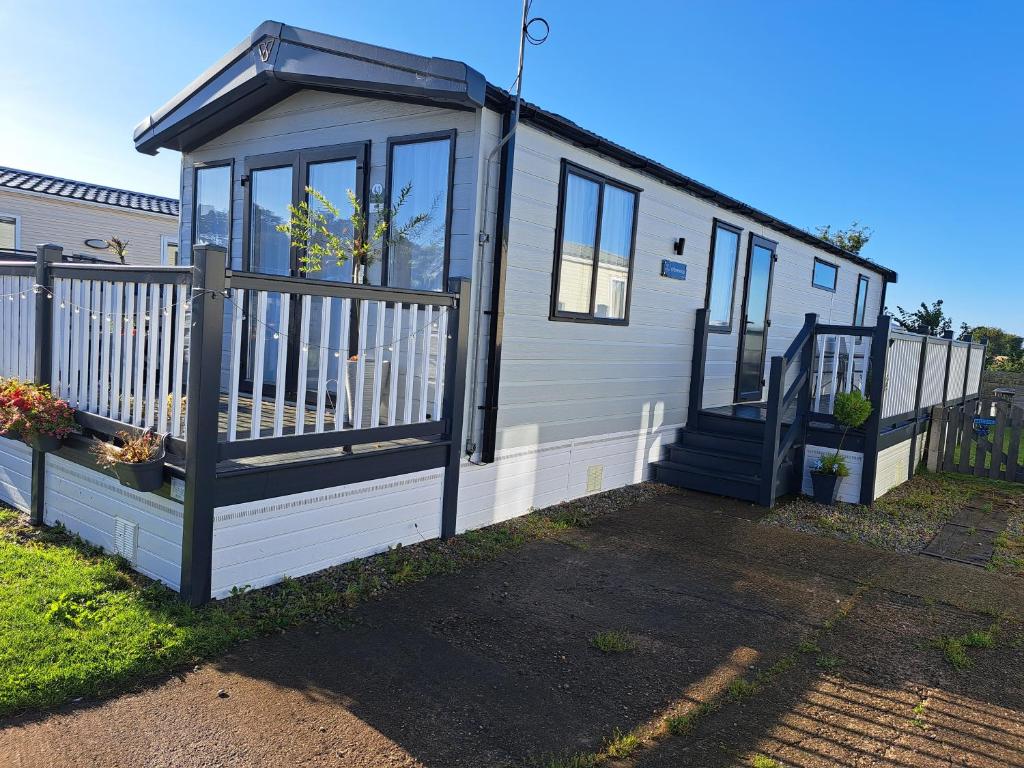una casa pequeña con porche y valla en 41 Park Lane Patrington Haven 2 bedrooms sleeps 6 five stars park, en Patrington