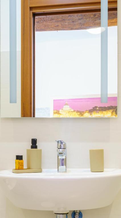 a white bathroom sink with a window above it at Da Rocky in Riomaggiore