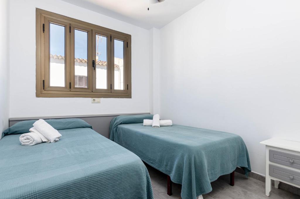 Postel nebo postele na pokoji v ubytování Alcudia Apartments