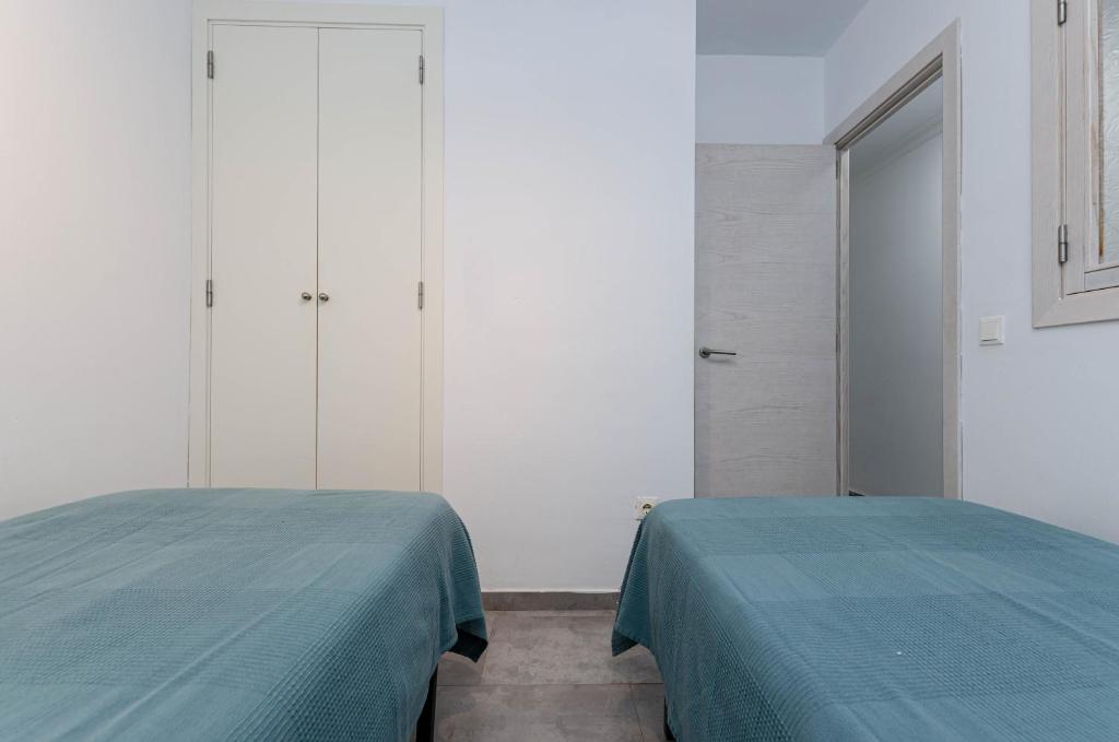Postel nebo postele na pokoji v ubytování Alcudia Apartments