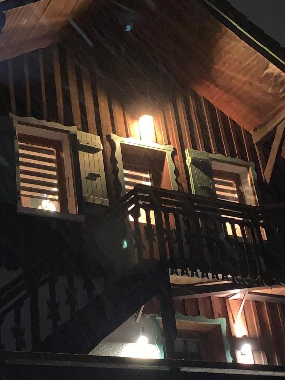 - un bâtiment en bois avec des fenêtres et un balcon dans l'établissement Apartment Alys, contemporary style apartment in mountain village, à Abondance