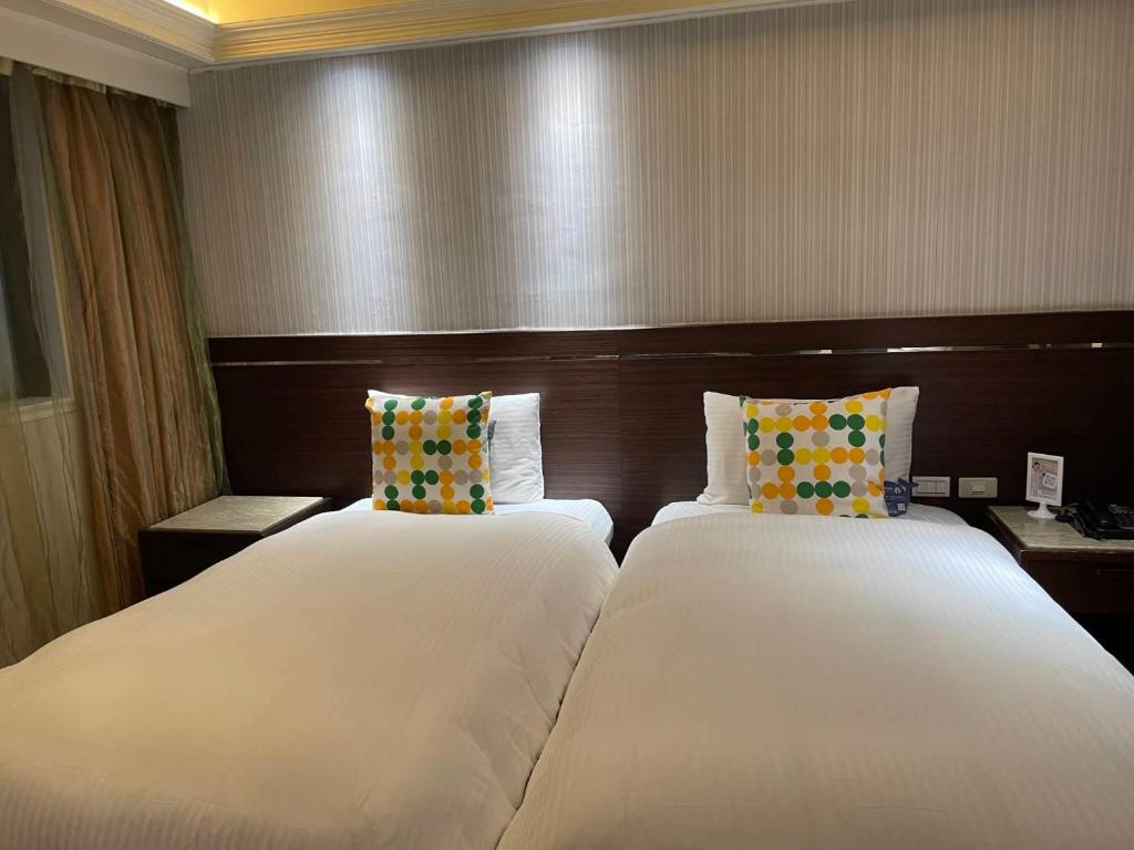 Postel nebo postele na pokoji v ubytování Tai Hope Hotel