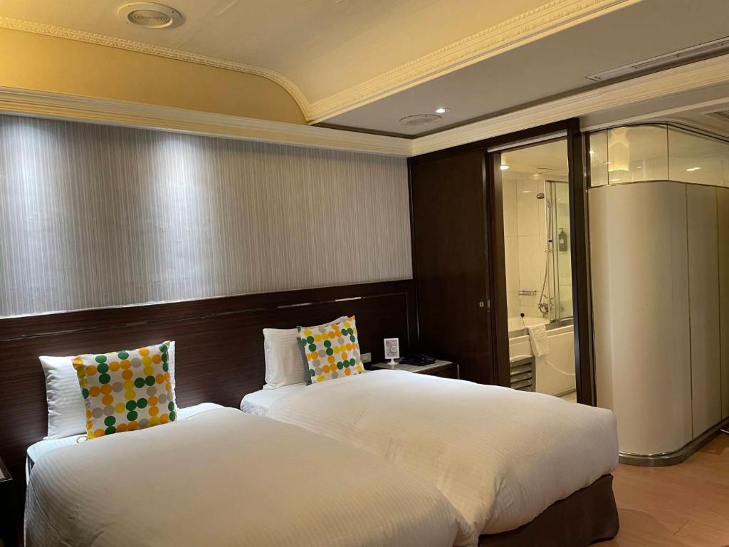 Postel nebo postele na pokoji v ubytování Tai Hope Hotel