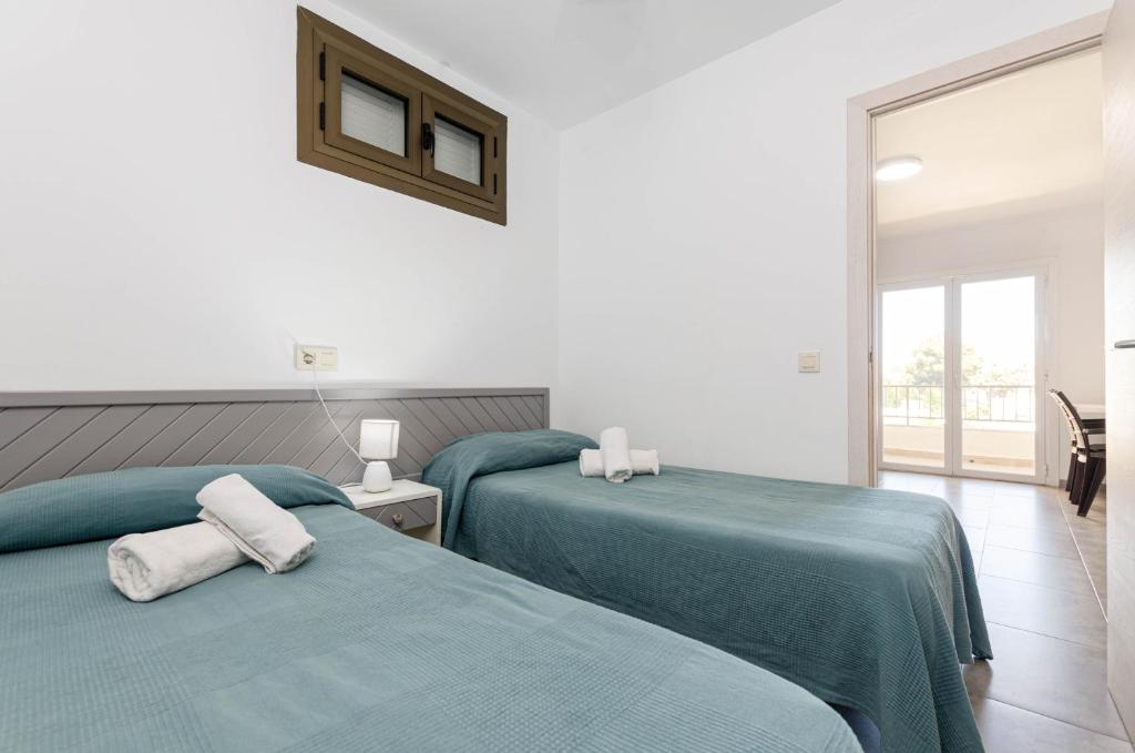 Postel nebo postele na pokoji v ubytování Alcudia Apartments