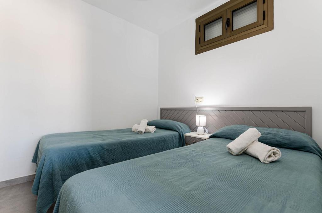 Postel nebo postele na pokoji v ubytování Alcudia Apartments