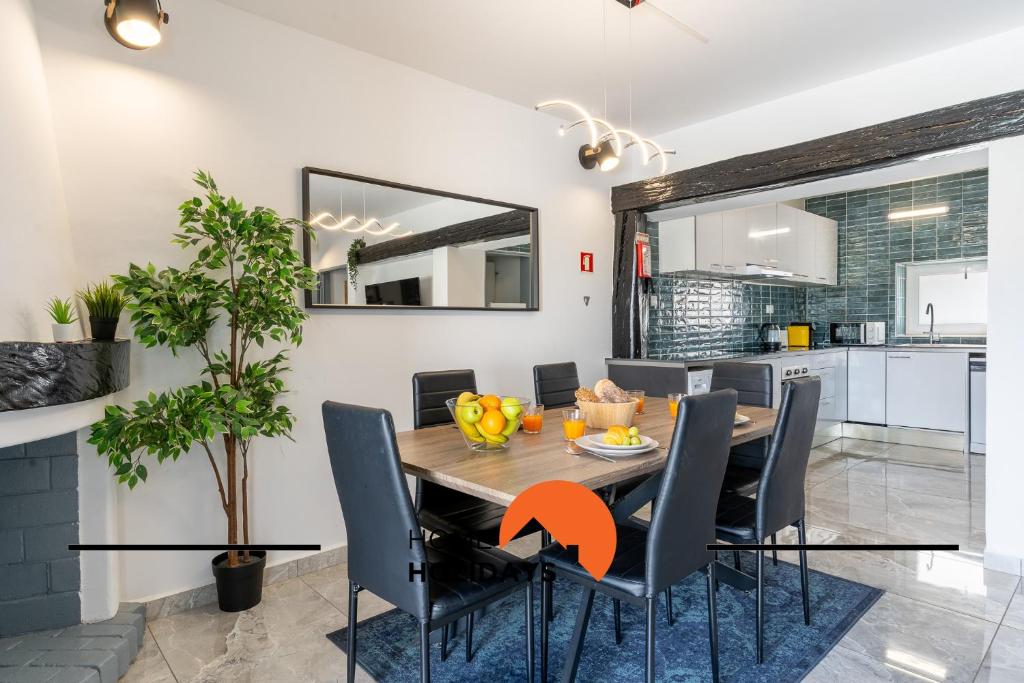 a kitchen and dining room with a wooden table and chairs at #268 Luxury Villa Pool & Views in Albufeira