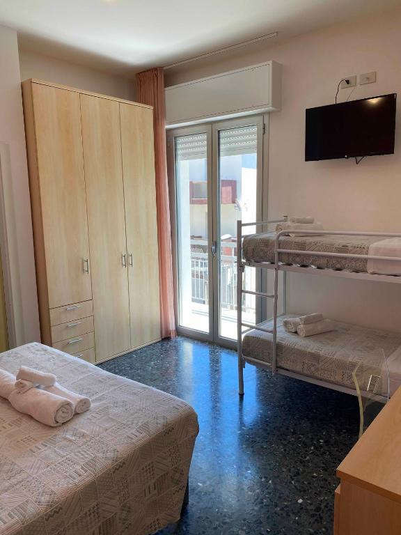 Postel nebo postele na pokoji v ubytování Hotel Loretta