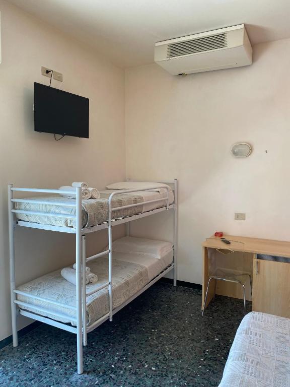 Postel nebo postele na pokoji v ubytování Hotel Loretta