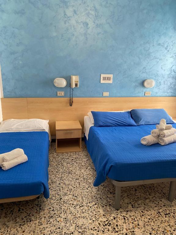 Postel nebo postele na pokoji v ubytování Hotel Loretta